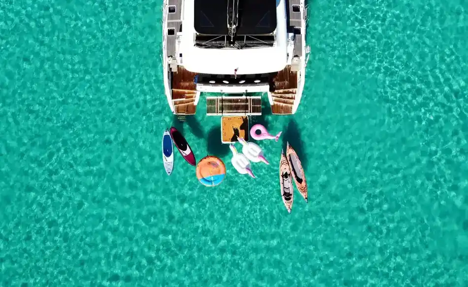 Paddleboards and toys off a Lagoon at anchor
