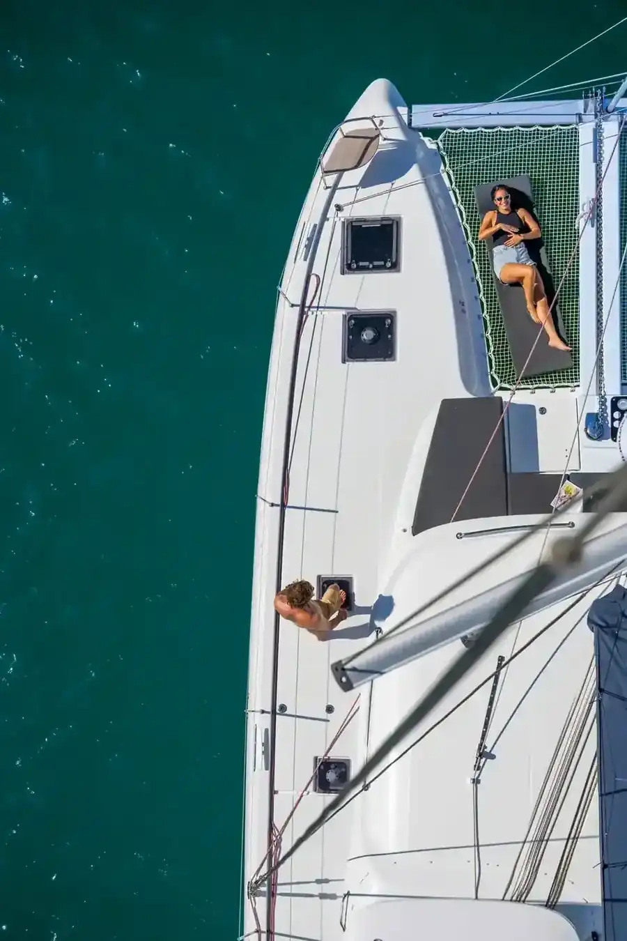 Guests on the forward trampoline of a Lagoon 43